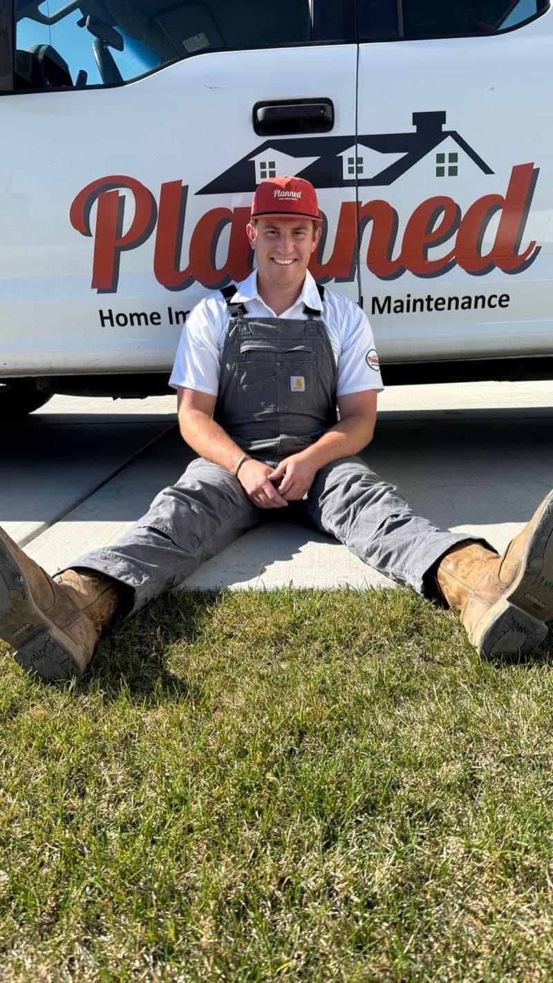 Planned technician in front of branded white truck