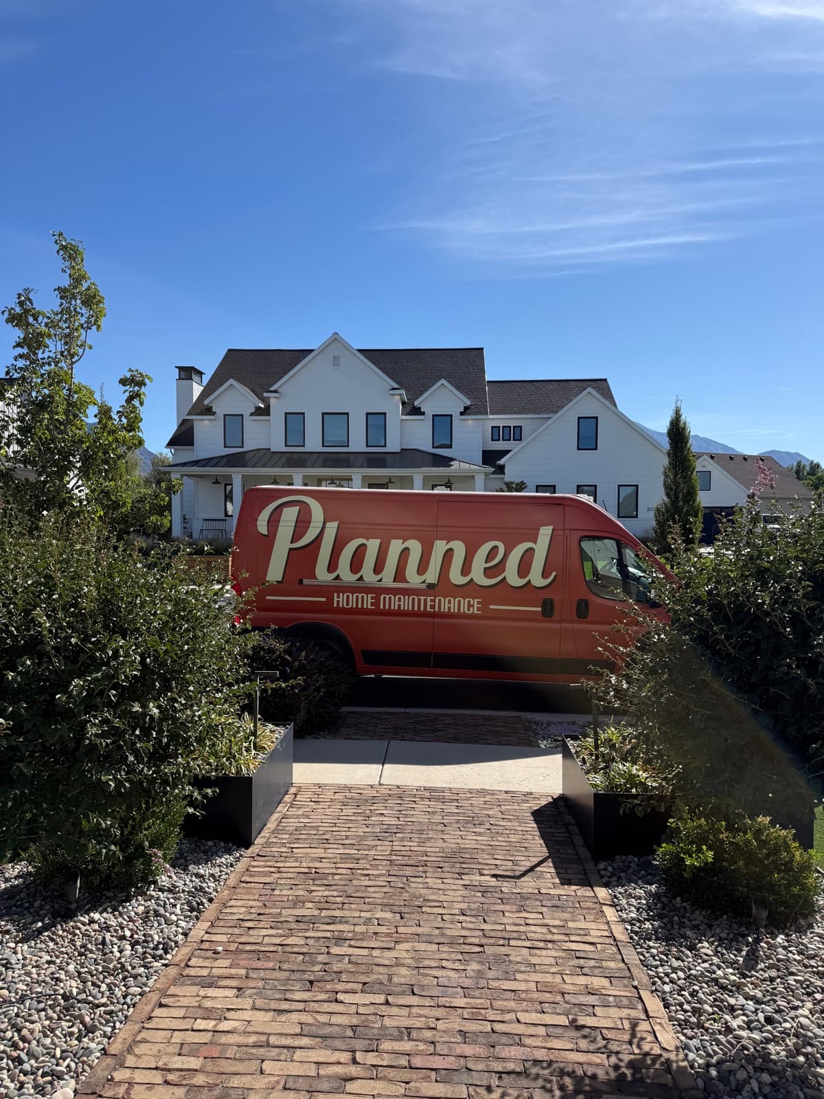 A Planned Home Maintenance van parked in front of a Utah home